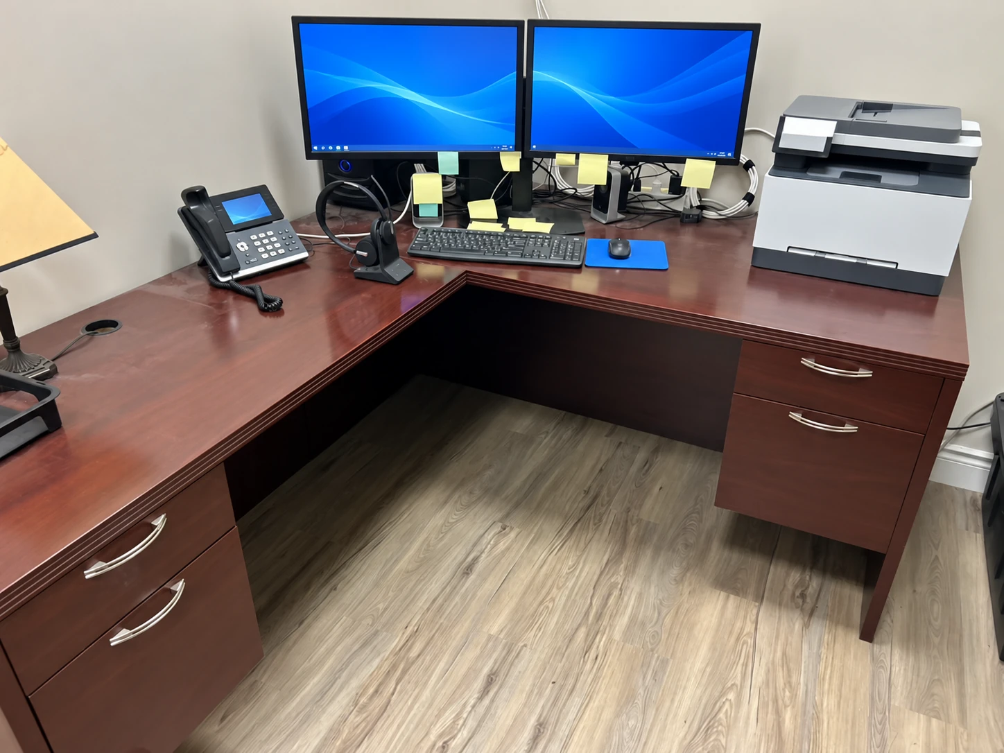 Dental office workstation with powered-on monitors and a desk phone