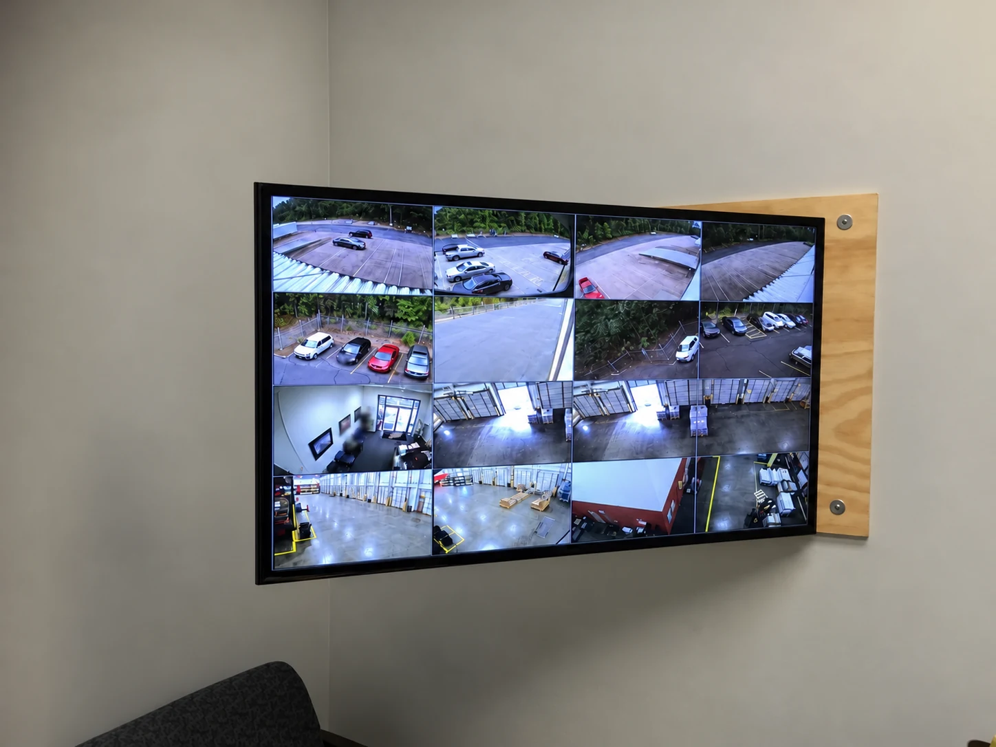 Multi-camera display showing warehouse areas with identifying details obscured